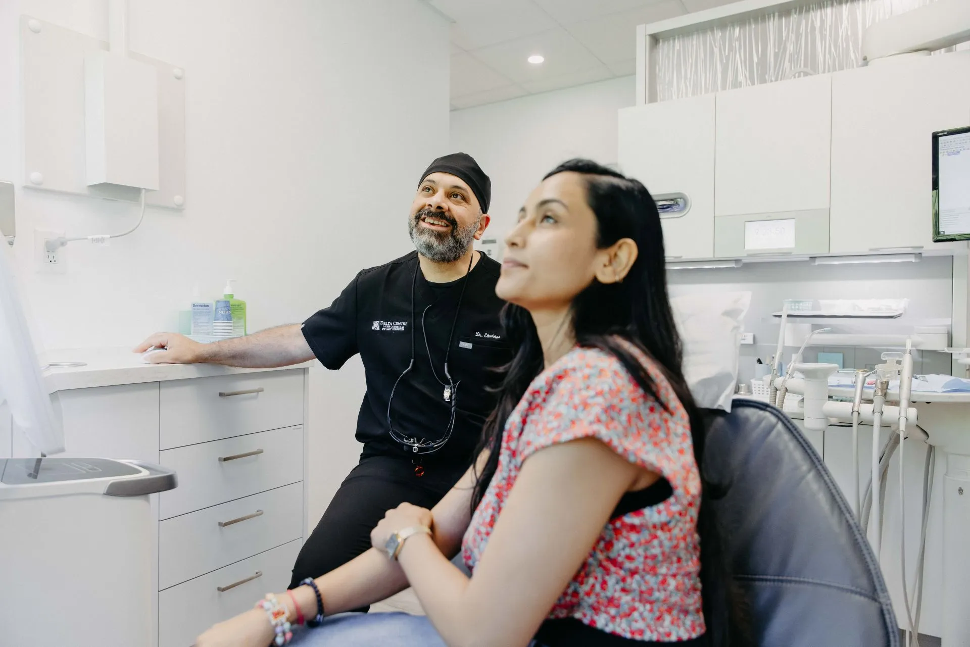 our dentist explaining the dental treatment to the patient at dental clinic in delta, bc